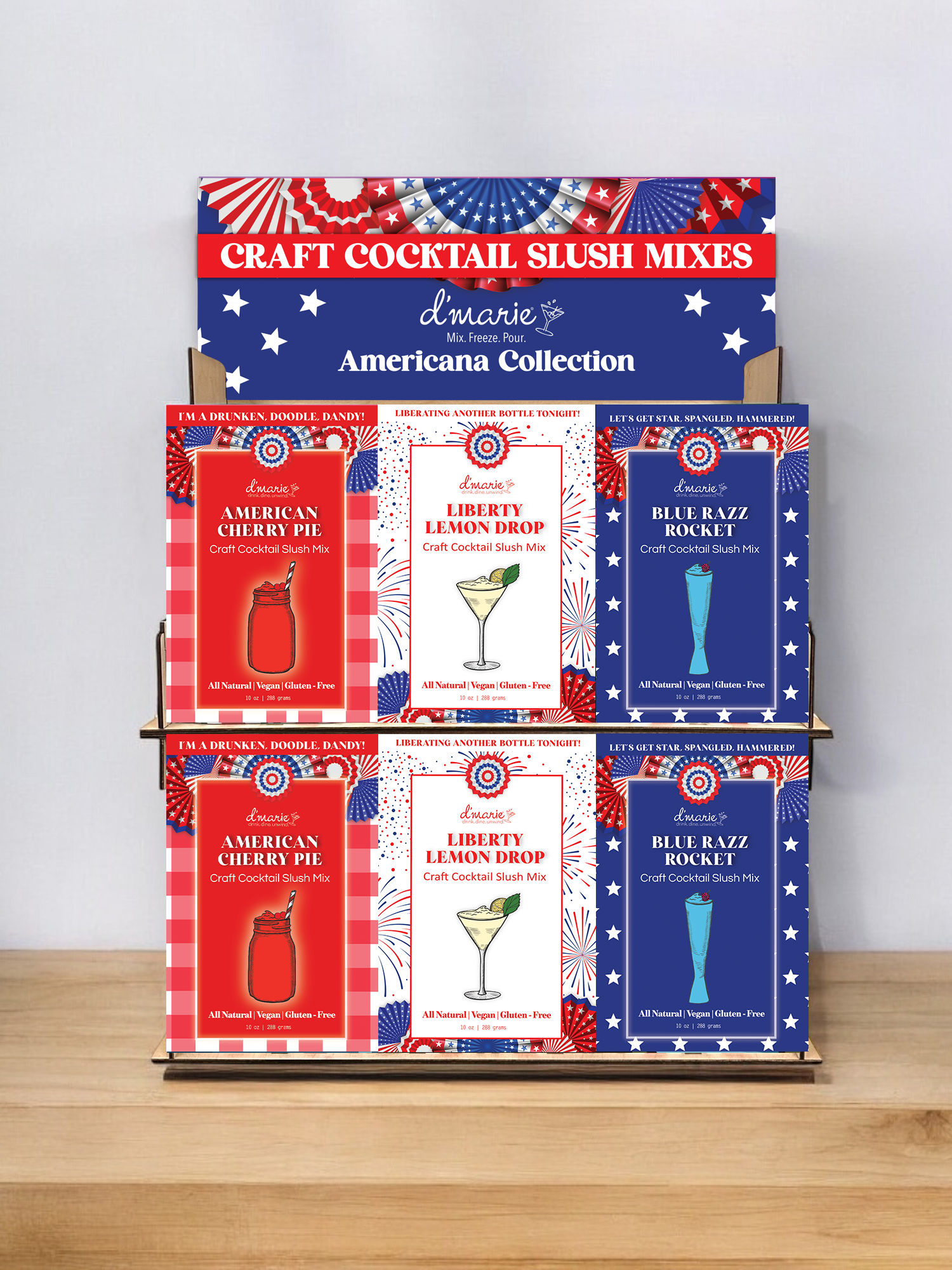 Display rack with patriotic-themed craft cocktail slush mixes in red, white, and blue packaging, featuring flavors like American Cherry Pie, Liberty Lemon Drop, and Blue Razz Rocket.