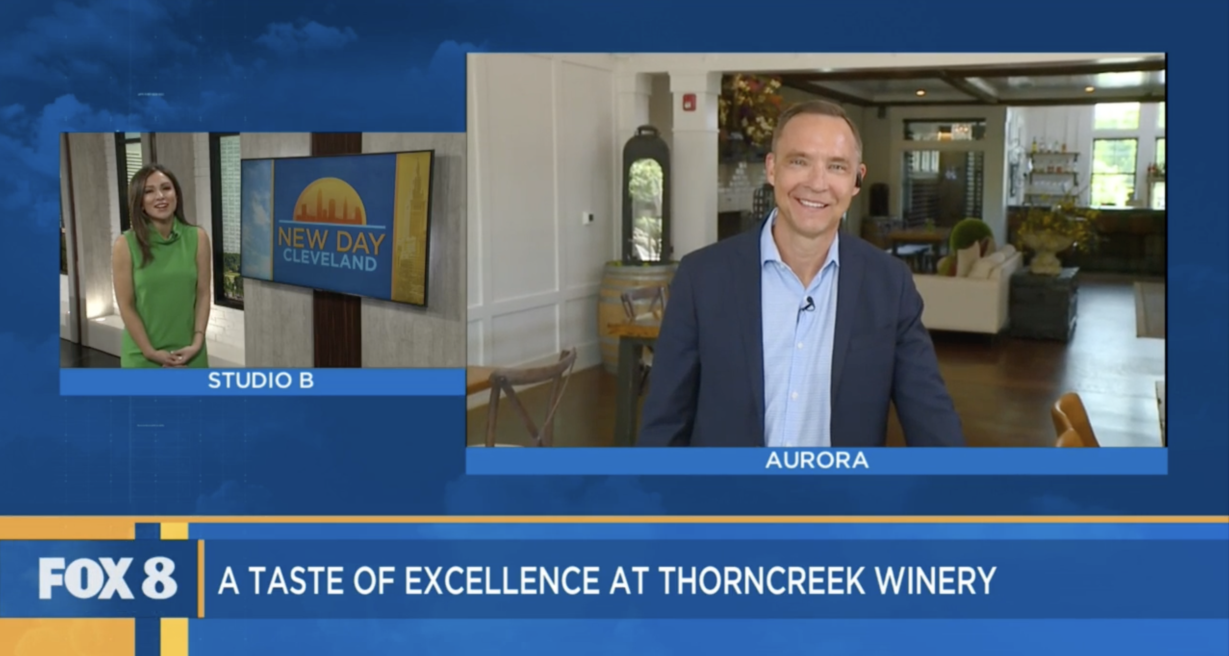 A television news broadcast featuring two hosts, a woman in a green dress on the left and a man in a suit on the right, with studio graphics and text indicating "New Day Cleveland" and "A Taste of Excellence at Thorner Creek Winery."
