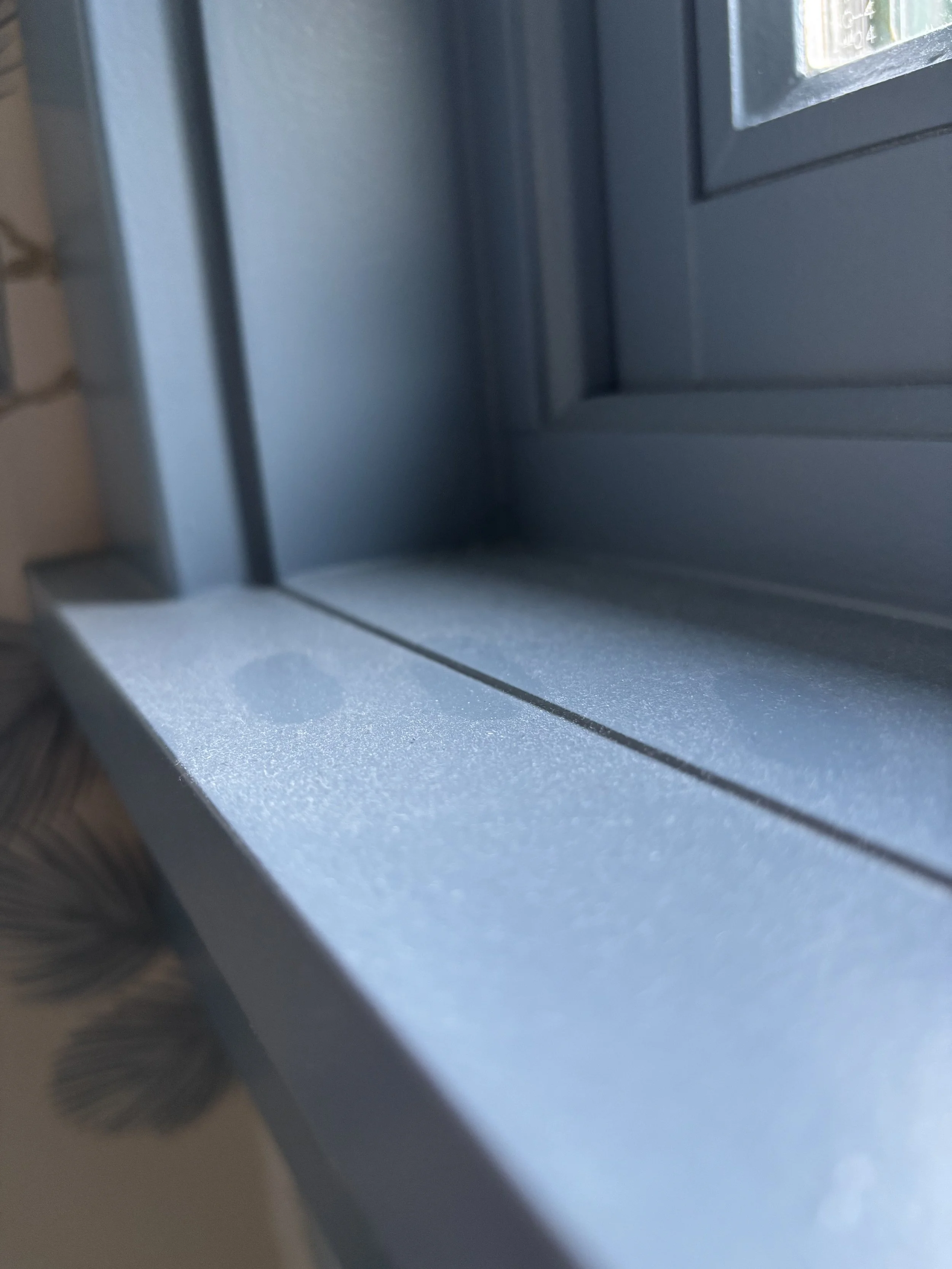Close-up of a metallic object with a textured surface, possibly part of a machine or equipment, with a dark cylindrical component on the left side.