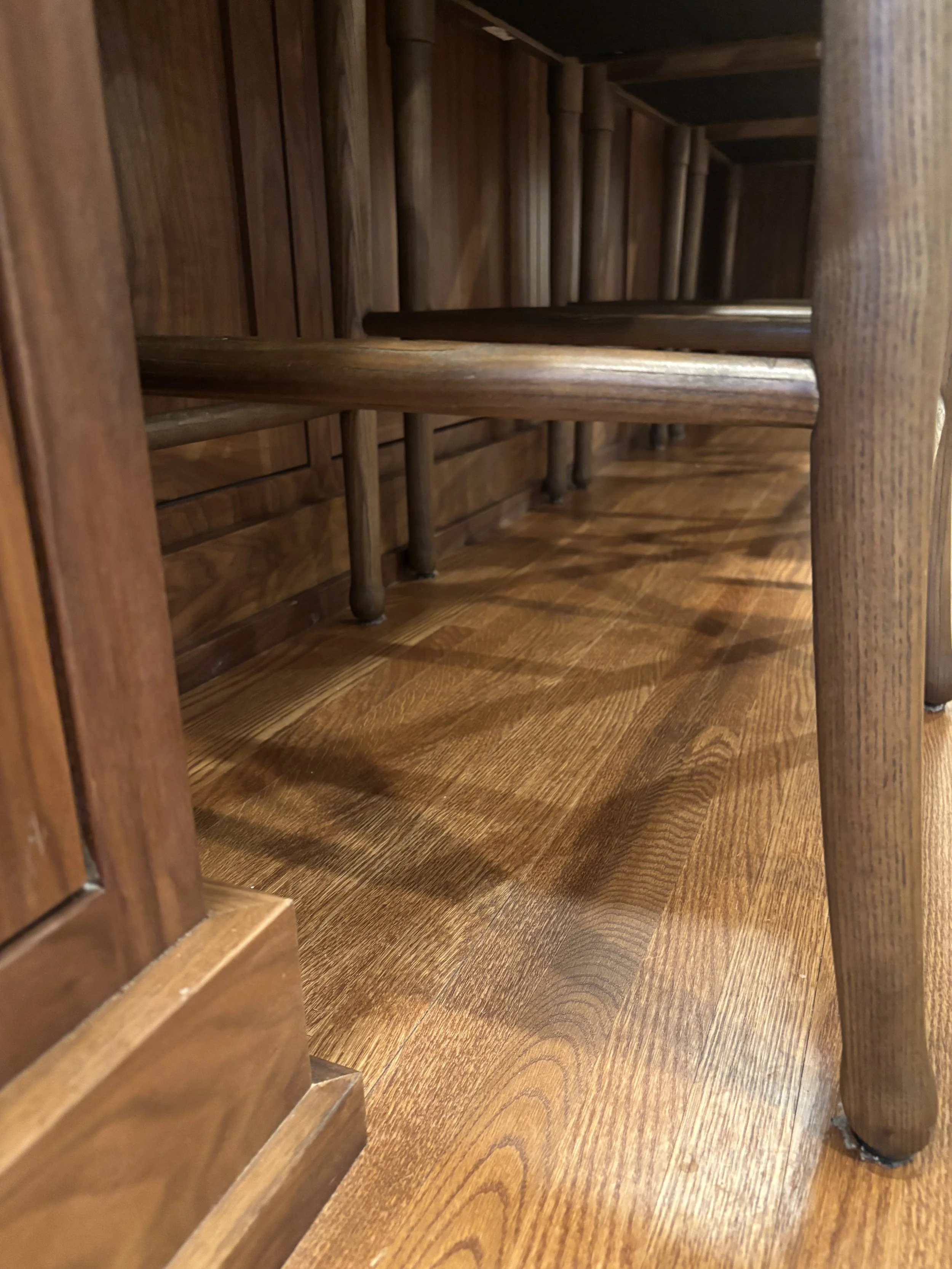 View of wooden staircase with polished wood steps and side panels.