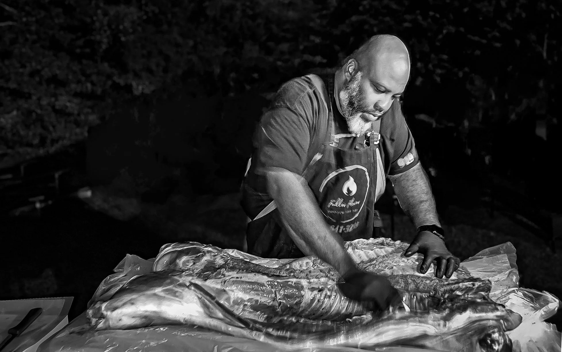 Pit Master, Martellis Fuller, prepares a whole-hog for BBQ before an event.