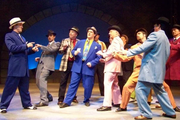 A group of men in suits and top hats