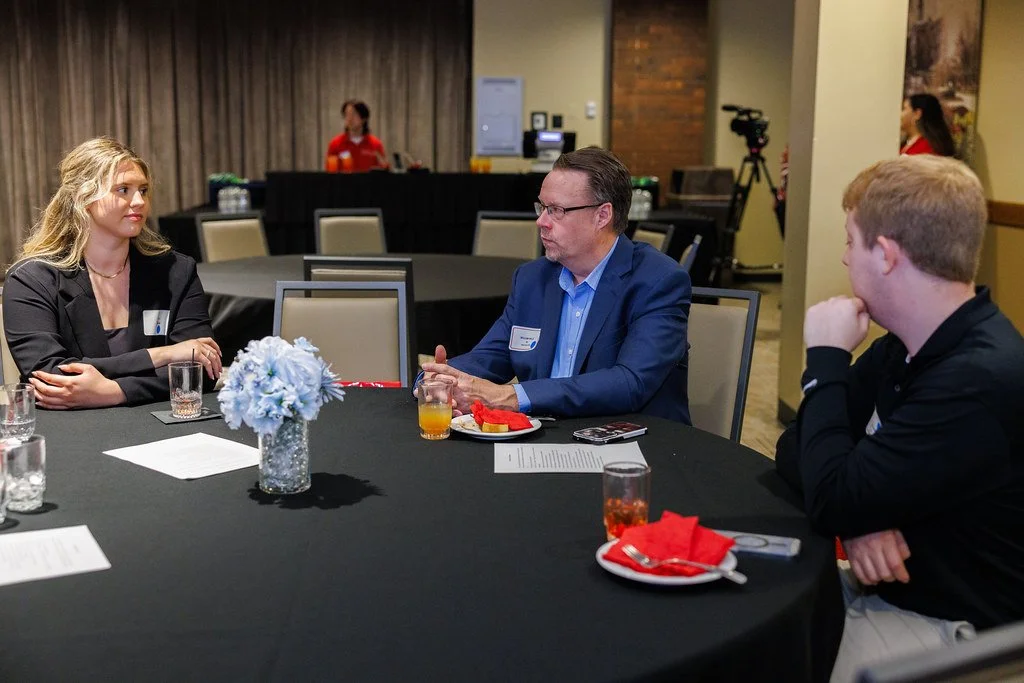 William Wille speaking with students during a networking event at Illinois State University