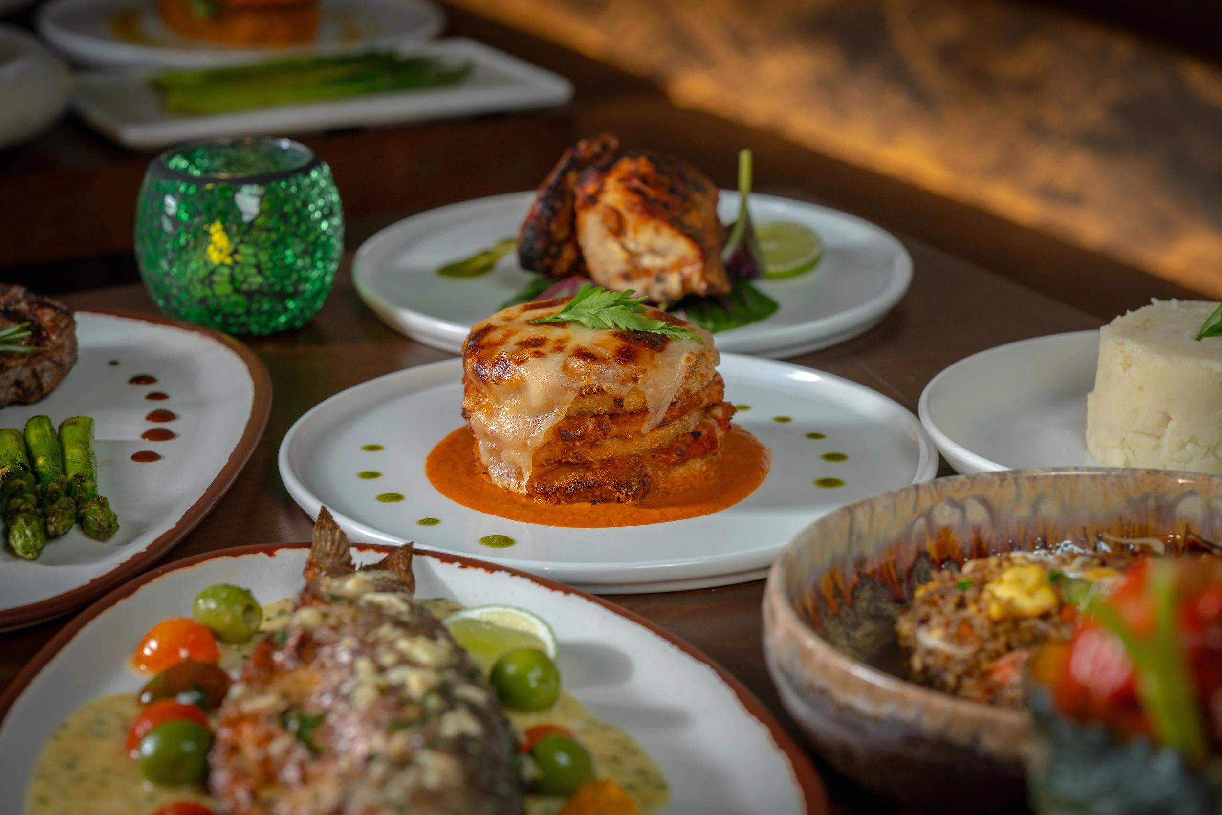 Assorted Caribbean dishes on plates and bowls.
