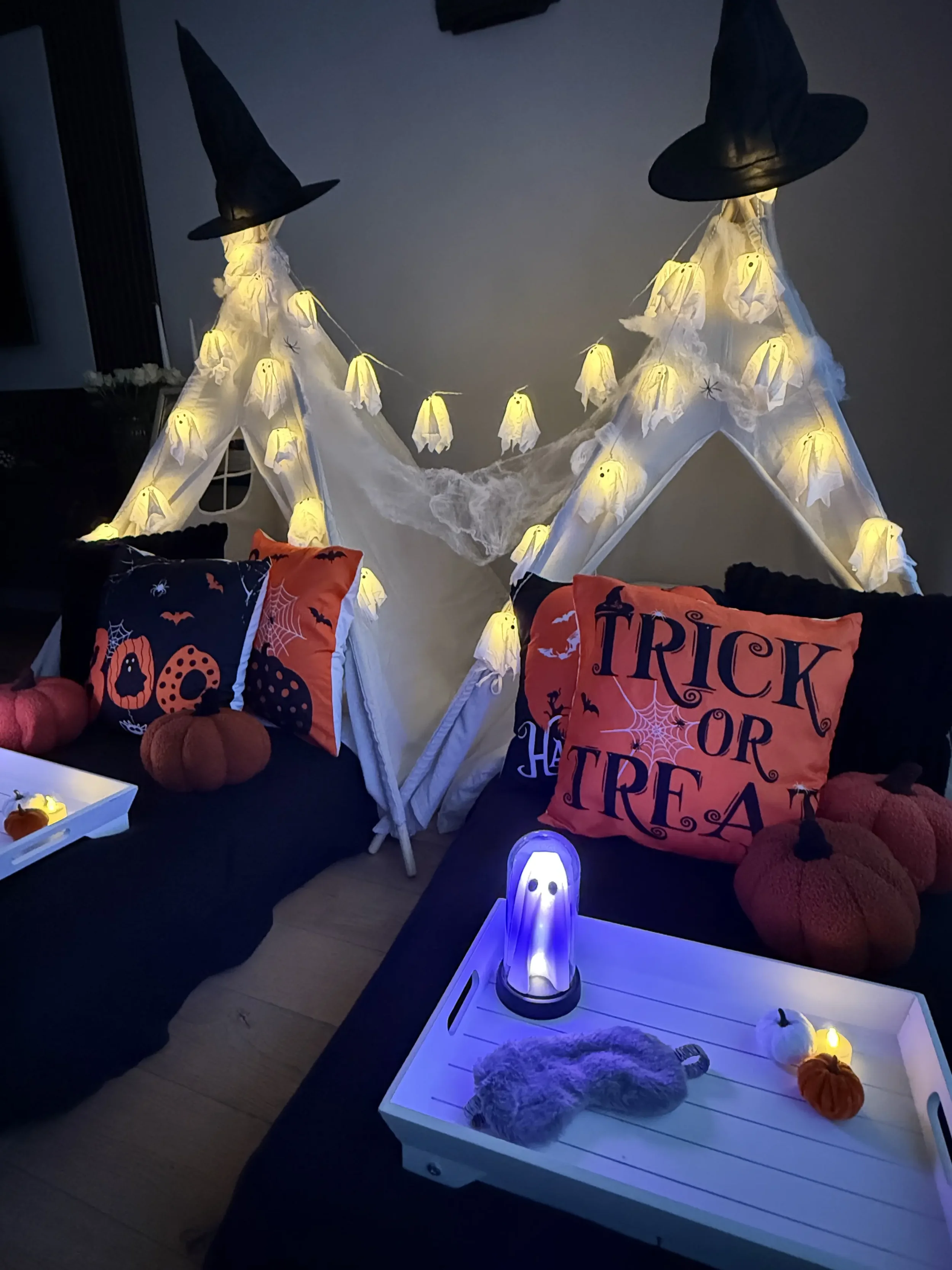 Halloween teepee sleepover party with a glowing ghost decoration and ghost string lights styled by Sweet Dreams Events in Surrey