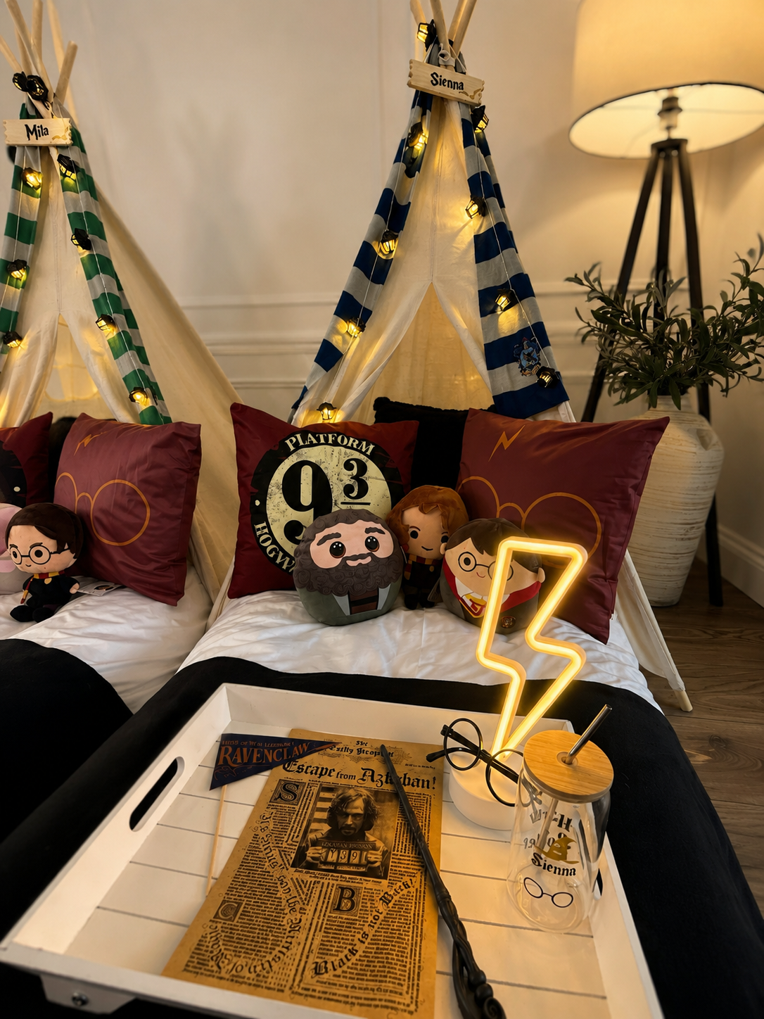 Girls sleepover party hire in Surrey, personalised Ravenclaw teepee named Sienna with fairy lights and a styled tray of wands, glasses and Daily Prophet props.