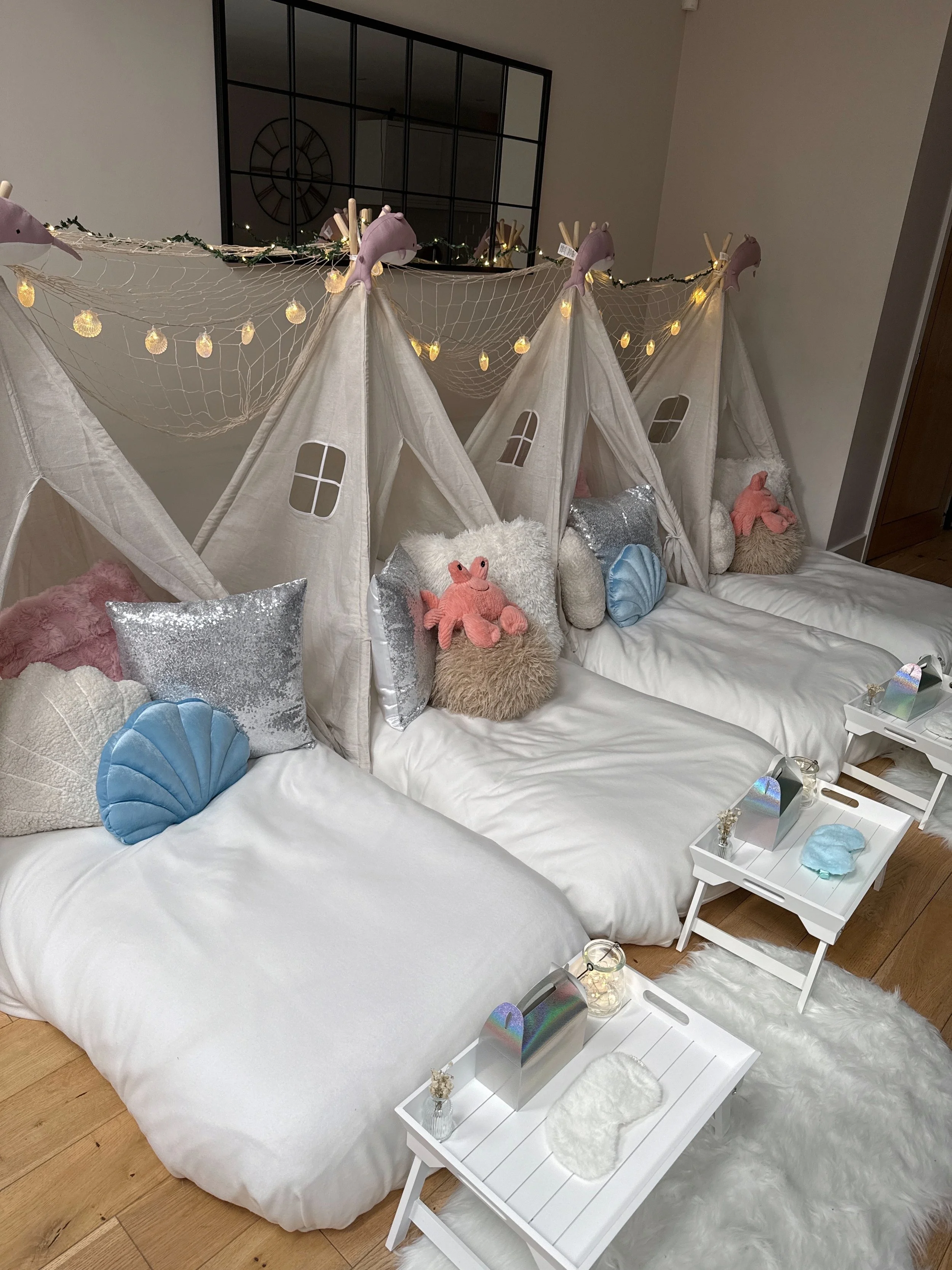 Mermaid Lagoon themed sleepover party with four teepees, seashell fairy lights, and personalised trays in Sussex.