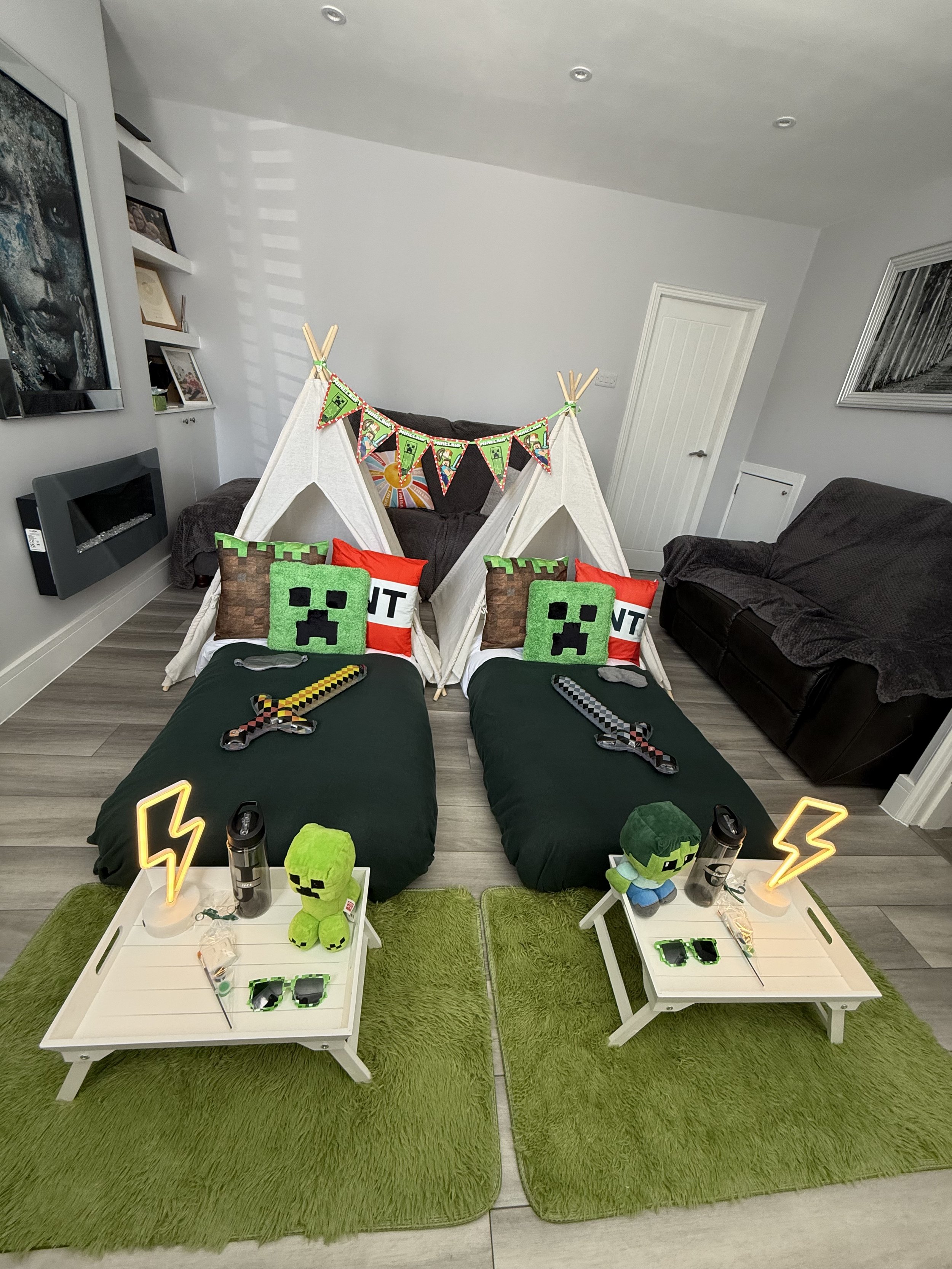 Symmetrical Minecraft teepee sleepover setup with green bedding, breakfast trays and glowing lightning bolts in Surrey, Sussex and Hampshire