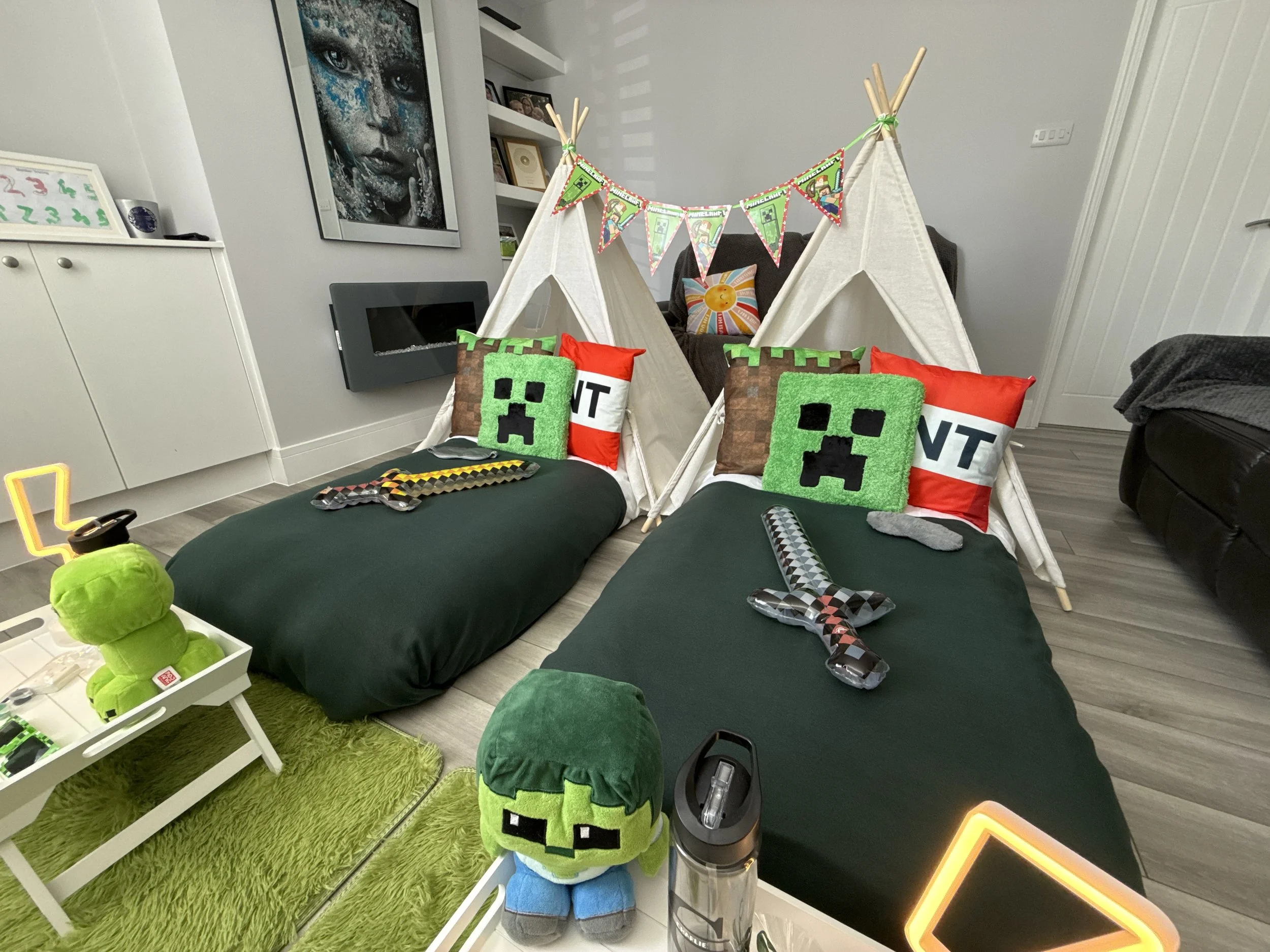 Minecraft teepee sleepover party in Surrey Weybridge with green and black styling, Creeper cushions and pixel art props by Sweet Dreams Events