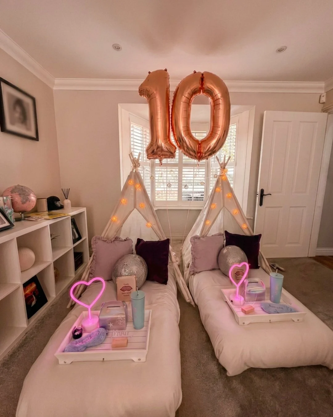 Glitterball Disco Dreams full teepee sleepover party setup by Sweet Dreams Events showing three cream teepees with disco ball fairy lights, neon pink heart lamps, silver tinsel backdrop and pink light projecting on the ceiling, styled for a girls sle