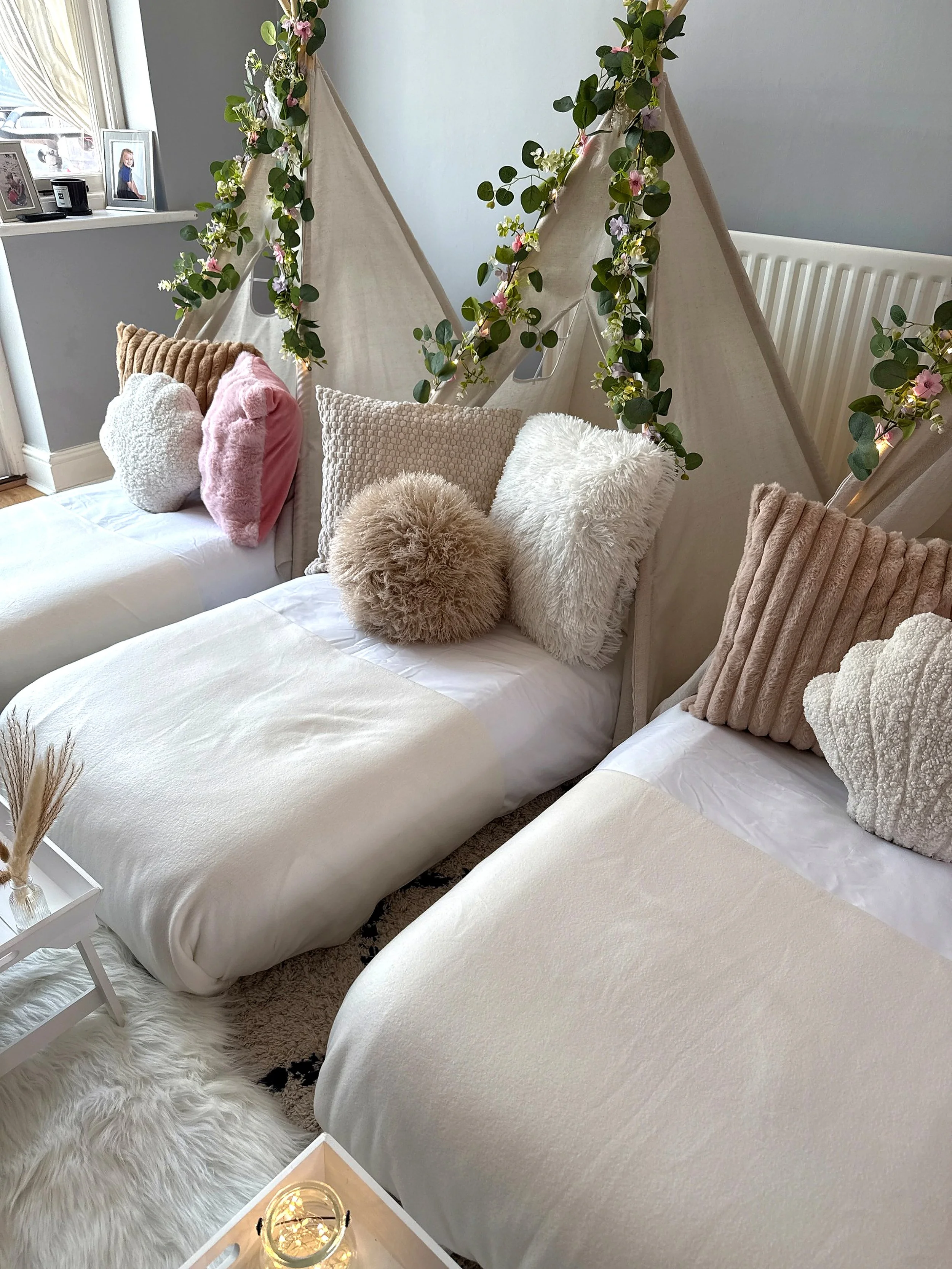 A closer look at our boho sleepover party styling, with neutral bedding, soft textured cushions and flower covered teepees. Every sleepover is carefully set up in your home, creating a warm and cosy space ready for the children to enjoy.