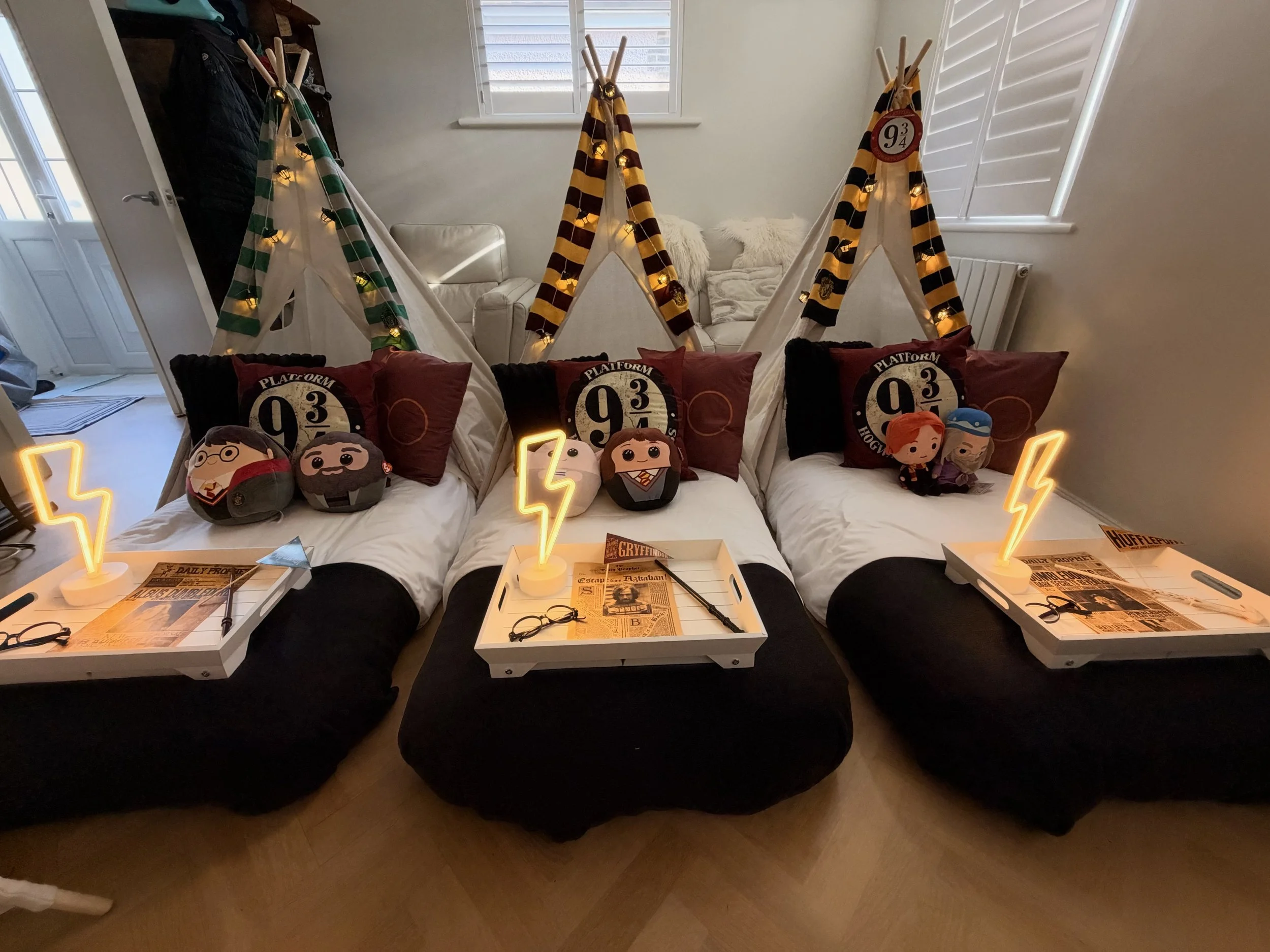 A row of cosy dens ready and waiting, fairy lights on and beds turned down for an unforgettable night.