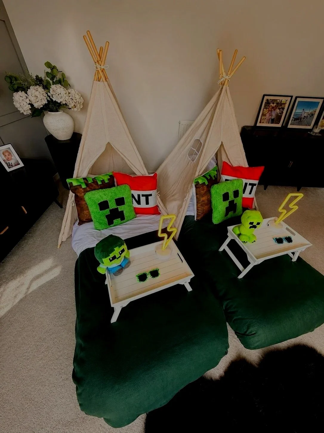 Minecraft Sleepover teepee party by Sweet Dreams Events showing single teepee in evening light with glowing lightning bolt neon lamp, Creeper plushie and pixel sunglasses on breakfast tray for a Minecraft birthday party in Surrey