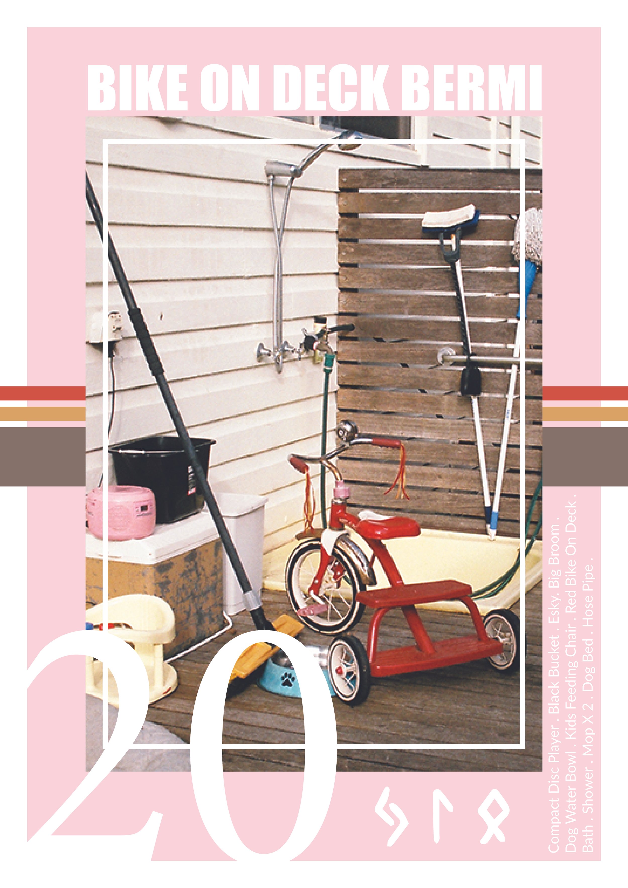 A collection of children's toys and outdoor equipment, including a red tricycle, a small pink heater, a black bucket, and a mop, all placed on a wooden deck with a beige wall and a wooden partition in the background.