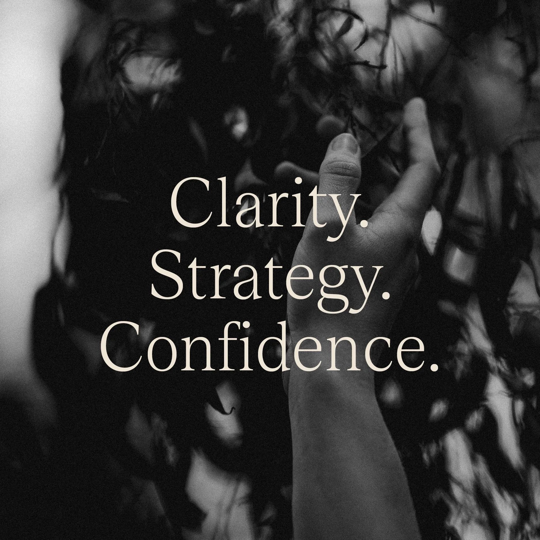 Close-up black and white photo of a person with curly hair touching their face with their fingers, with text overlay stating, 'Clarity. Strategy. Confidence.'