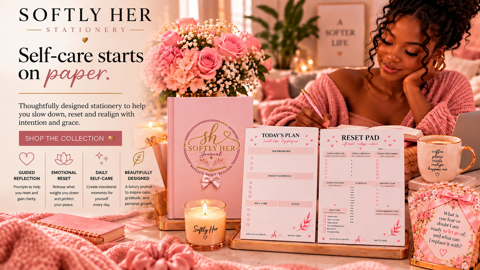 Display of Self-care stationery including a pink journal titled 'Softly Her Journal,' a daily planner, a reset pad, a candle, a pink floral arrangement, a pink mug with a motivational quote, and various pink decorative elements on a table, promoting a self-care brand called 'Softly Her.'