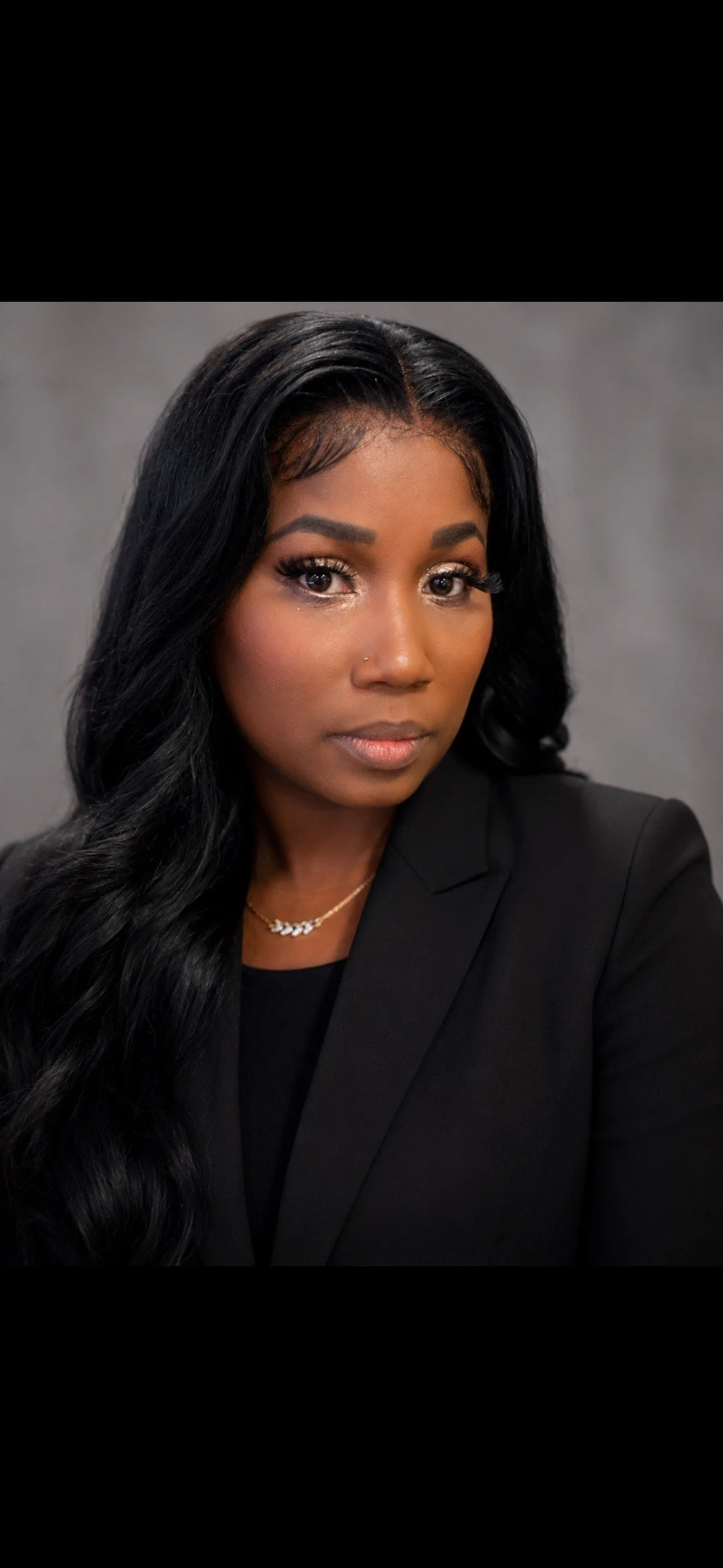 Cheryl Spinner, founder and owner of Honor Line Residential Solutions LLC, wearing a professional black blazer and gold necklace.