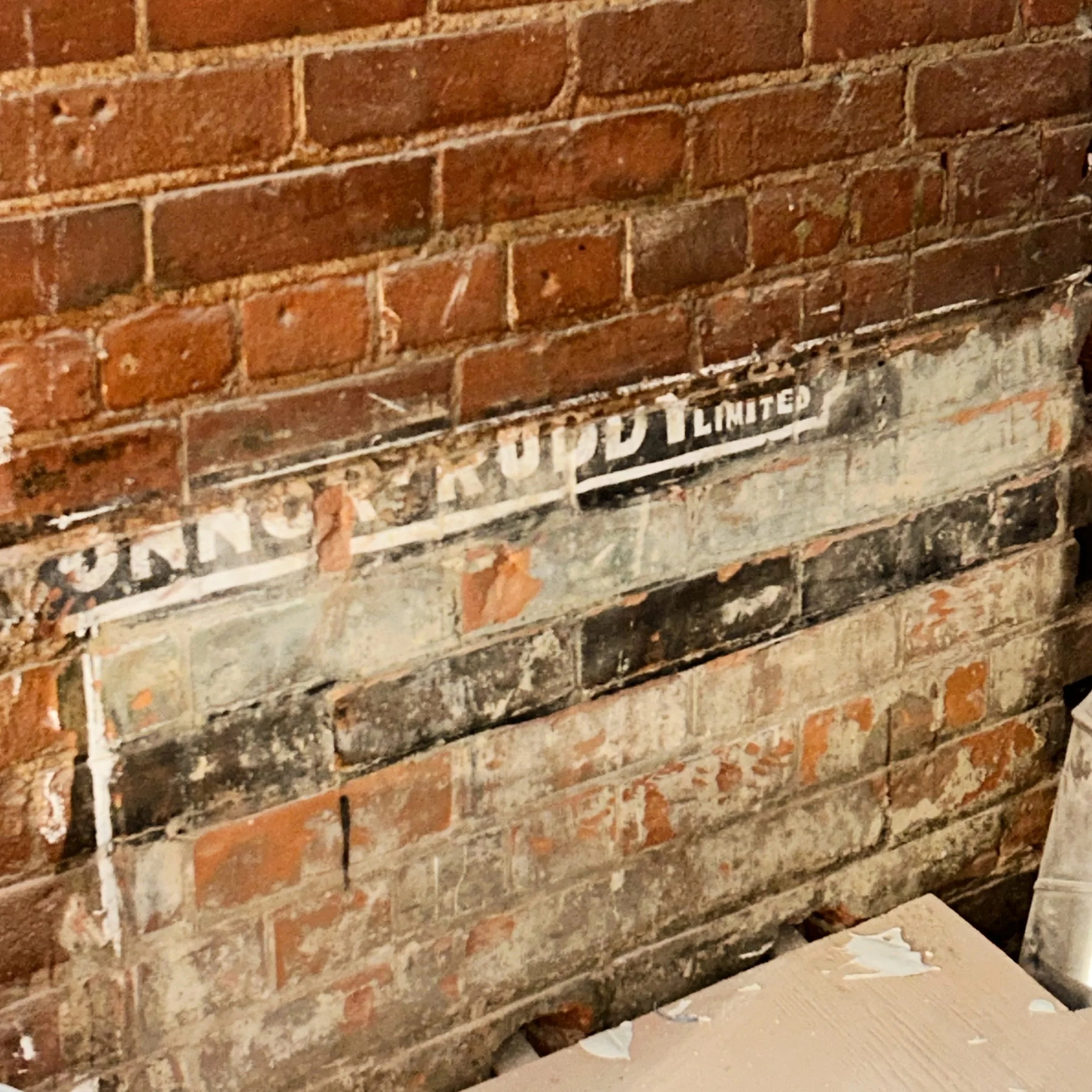 Renovations have a funny way of surprising you 🥹

We were scraping back the walls when the brick started telling us its own story, a little advertisement, preserved, like it had been waiting for us all along. 

A reminder that this space has lived m