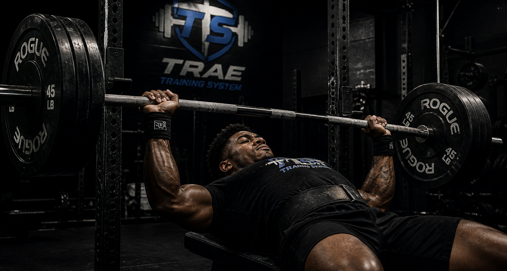 Competitive powerlifter performing a heavy bench press at Trae Training System. Specialized strength coaching for USAPL athletes focused on increasing their squat, bench, and deadlift totals