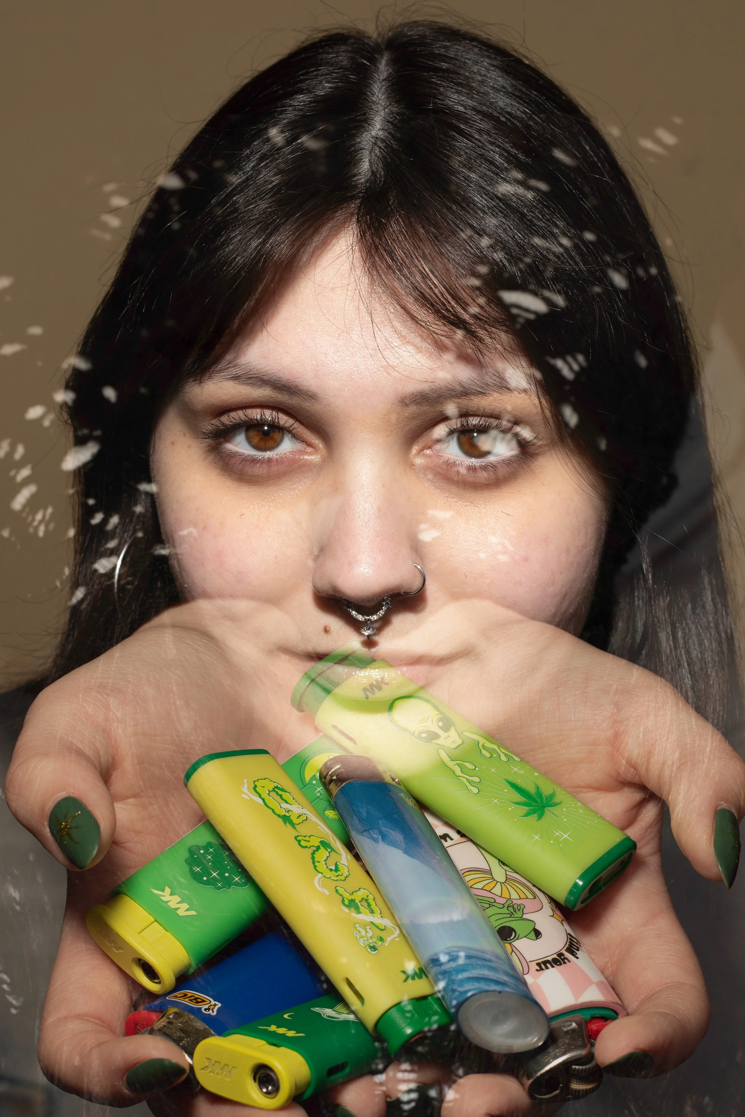 Zoey holding lighters. Photographic illustration.