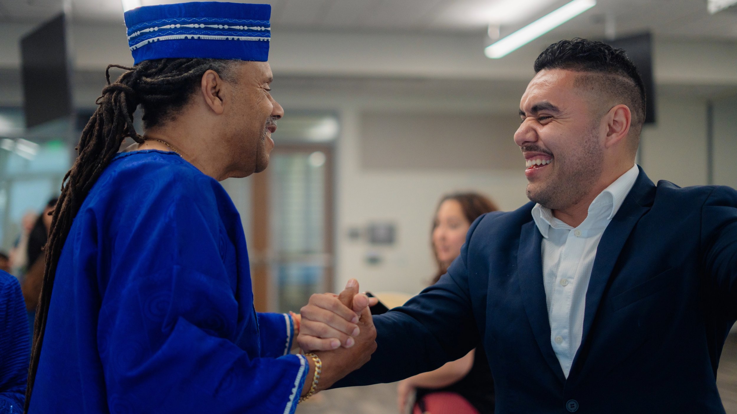 Clyde Virges congratulates Antonio López on his appointment as the new San Mateo County poet laureate May 5 at the Regional Operations Center in Redwood City.