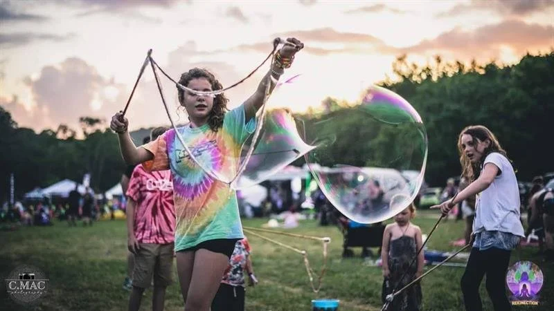 Girl making a giant soap bubble