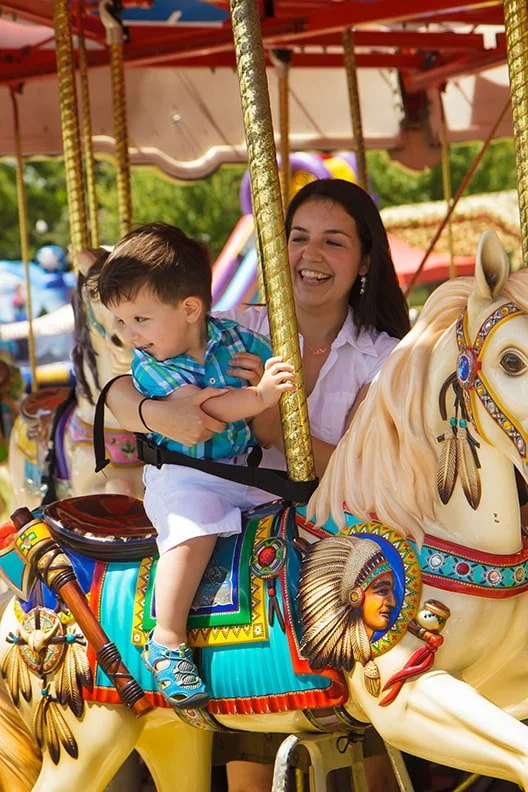 Mom and little boy on the Merry Go Round