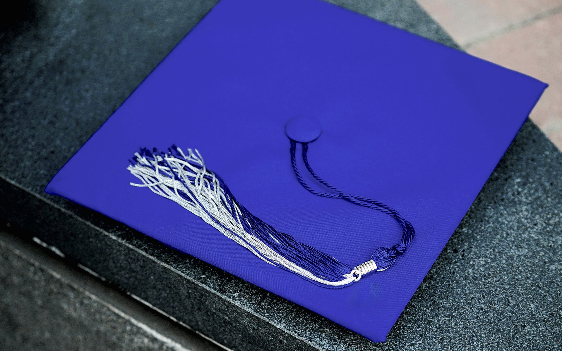 A blue mortarboard sitting on a table