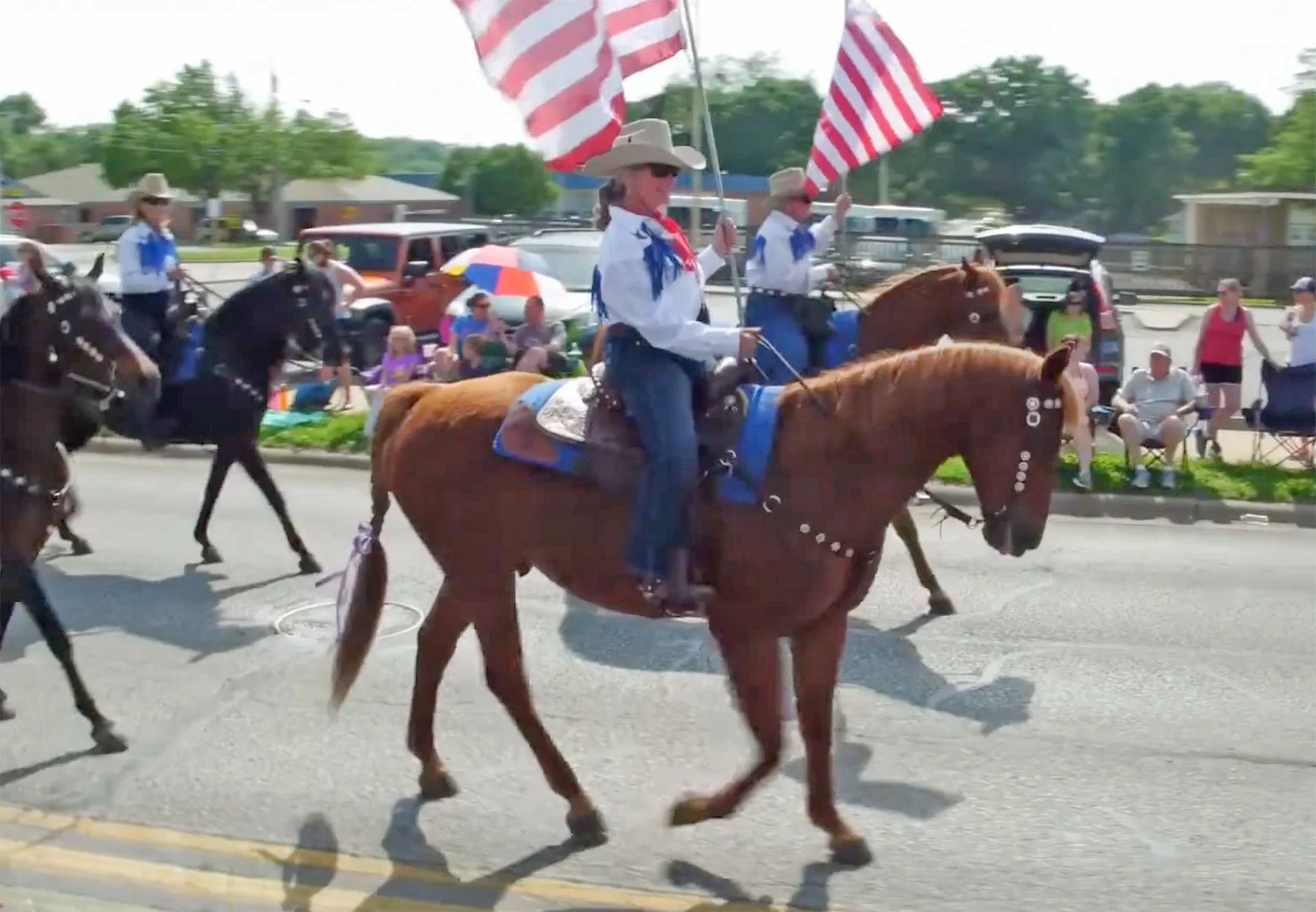 horses and riders with flags in a parade