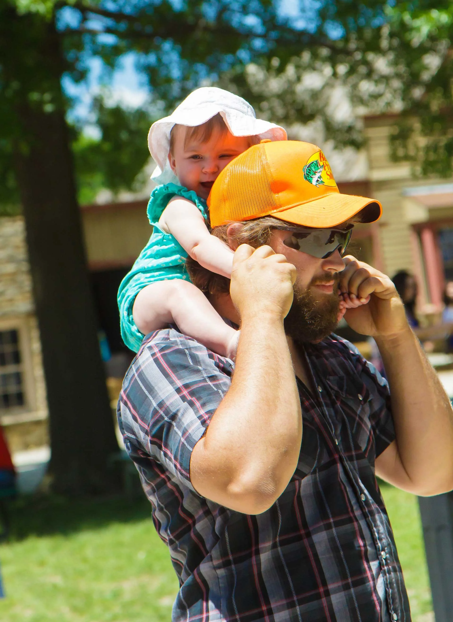 baby sitting on dad's shoulders