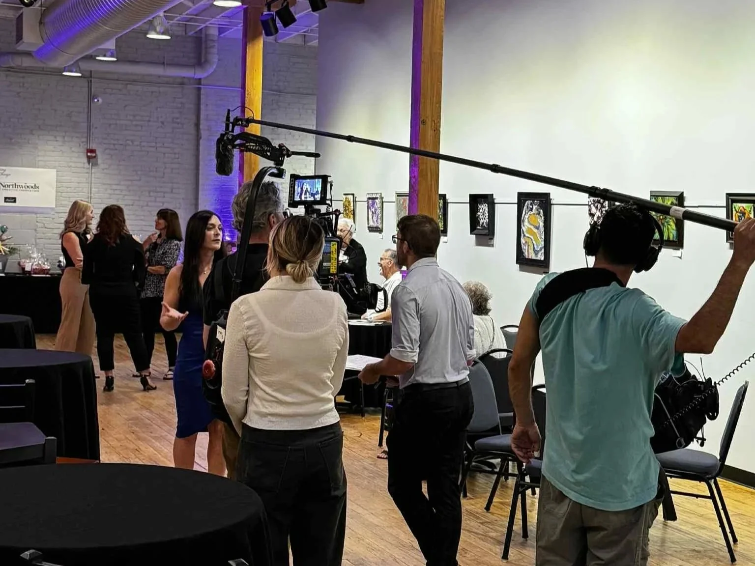 Melissa talking with 20/20 producers at the LOVE>hate 2025 butterfly legacy event