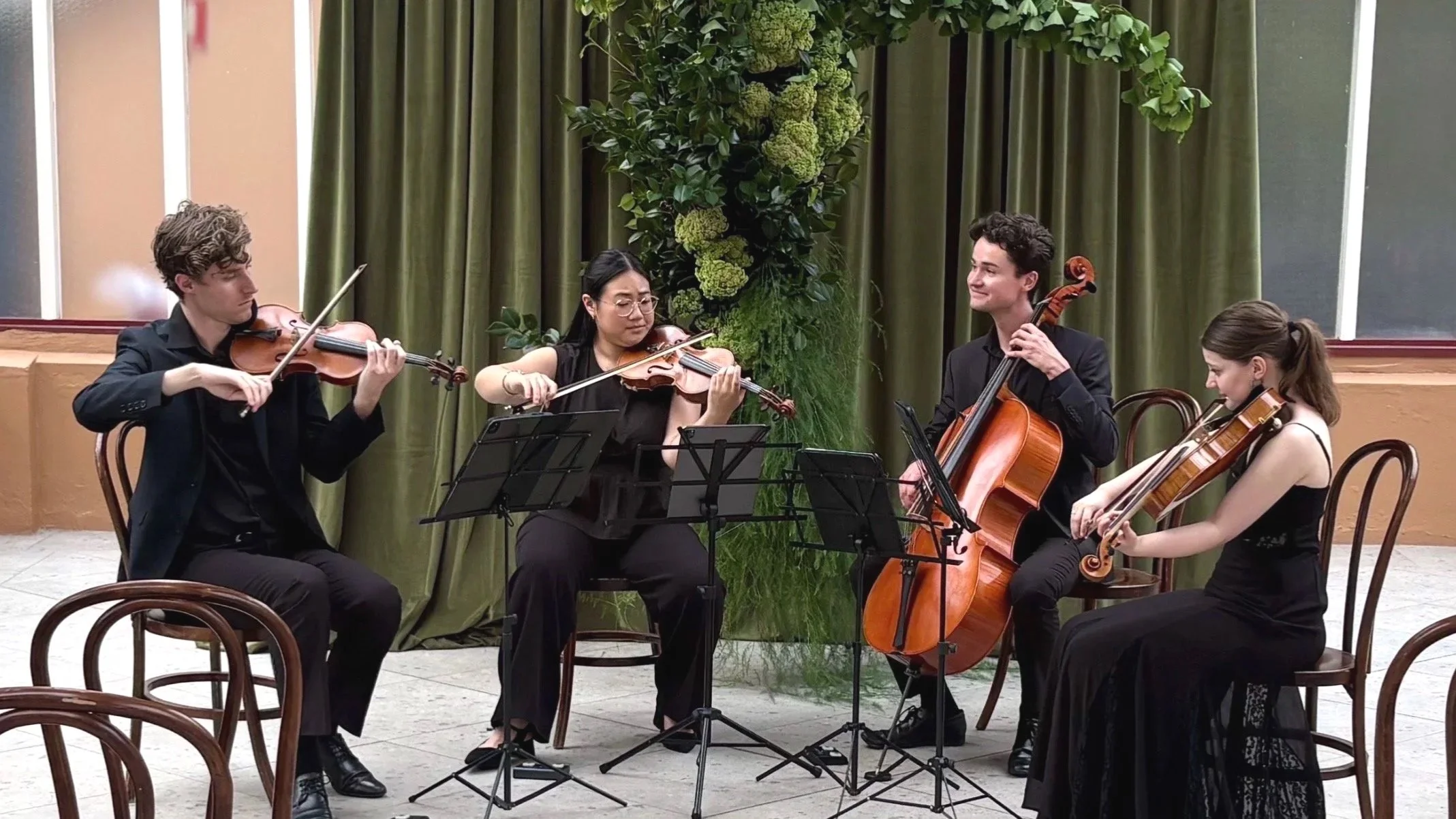 A string quartet playing in front of a beautiful wedding display in Sydney