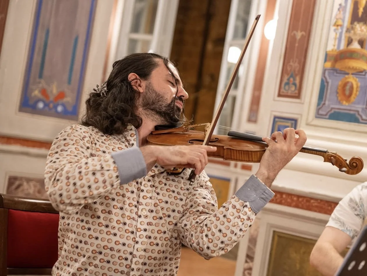 A Pursuit 19 violinist playing in a beautiful event space