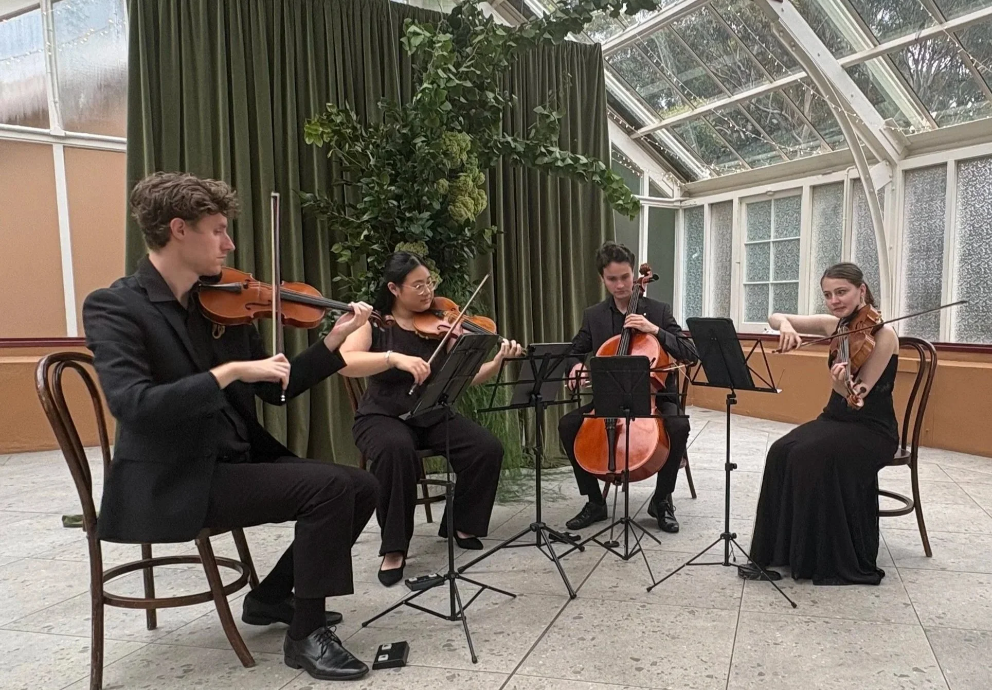 A Pursuit 19 string quartet performing at a wedding showcase in Sydney