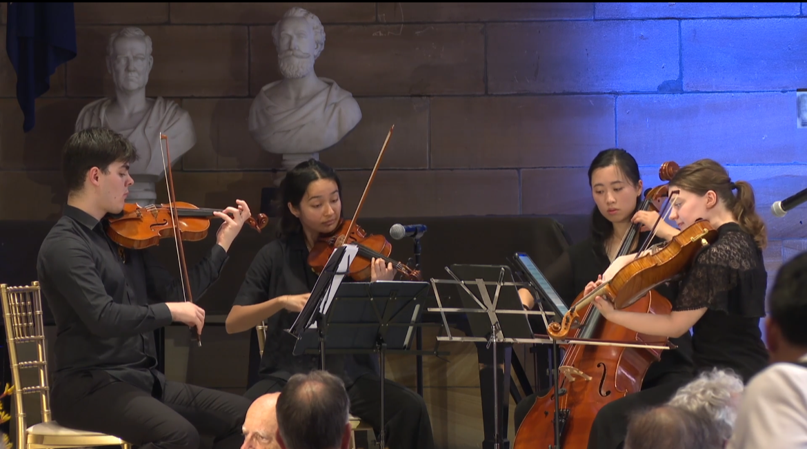 A Pursuit 19 string quartet performing at a corporate event at the University of Sydney's Great Hall 