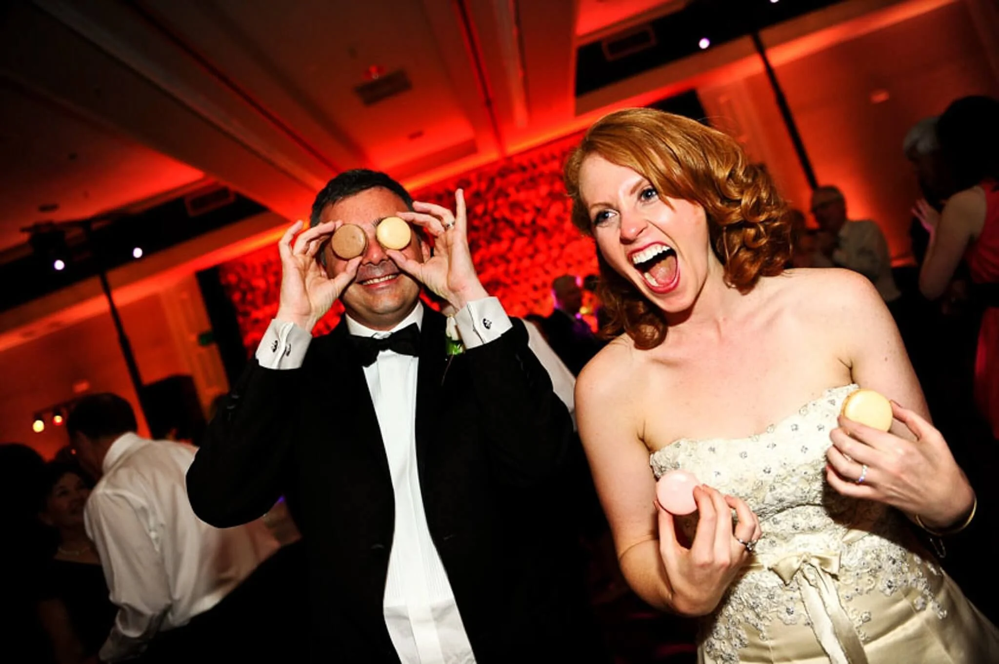 Couple celebrating at wedding reception playing with macarons captured in lo-fi home movie style Lake Tahoe camcorder rental