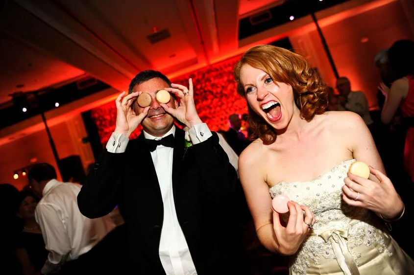 Couple celebrating at wedding reception playing with macarons captured in lo-fi home movie style Lake Tahoe camcorder rental