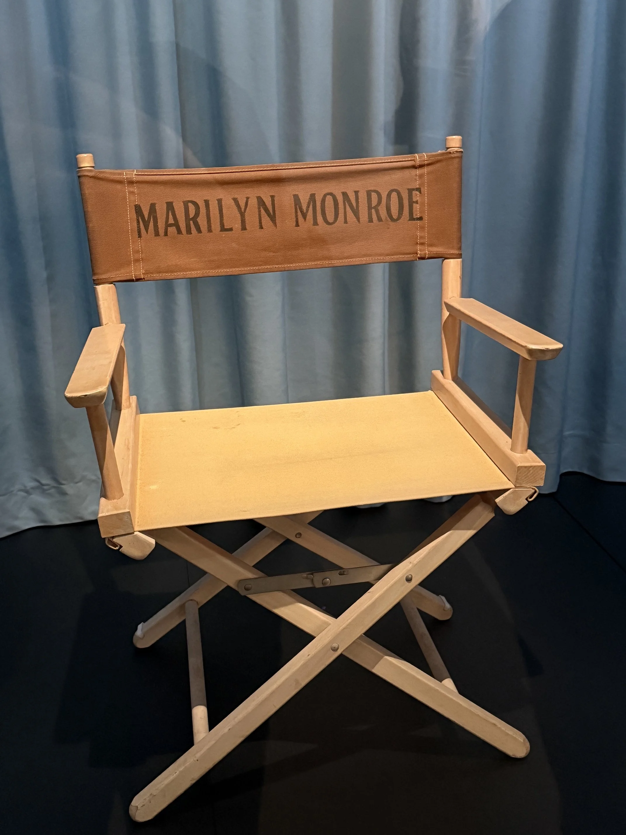 Display featuring photographs and memorabilia at the Marilyn Monroe Centennial Celebration Exhibit.