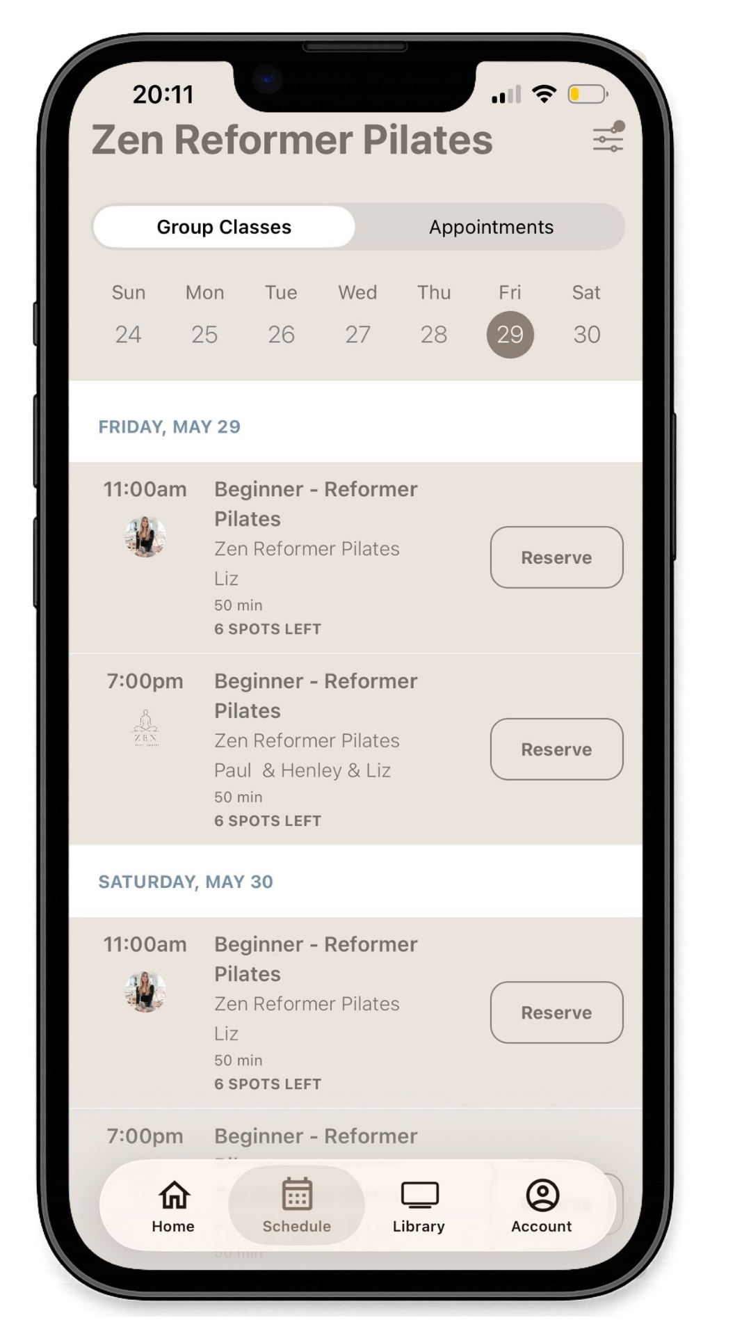 A smartphone screen displaying a Pilates class booking app called Zen Reformer Pilates. The schedule shows classes on May 29 and 30, with options to reserve spots for beginner reformer Pilates sessions at 11:00 am and 7:00 pm. The app has navigation icons for Home, Schedule, Library, and Account at the bottom.