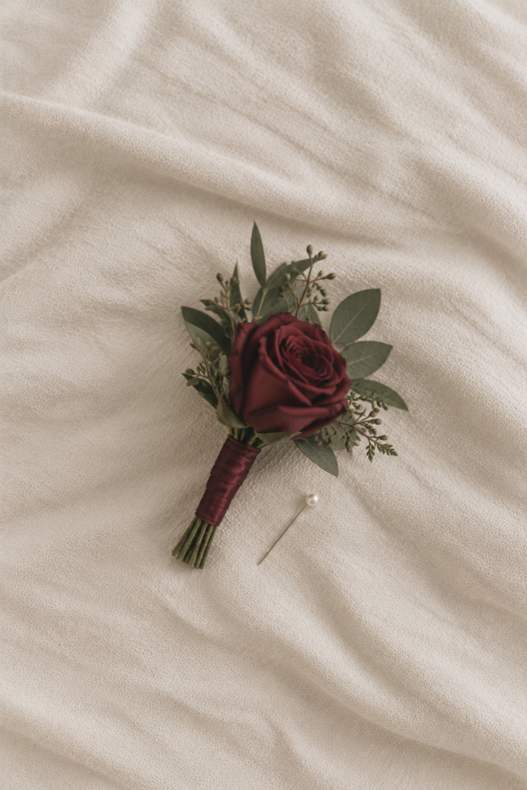 Burgundy Rose Boutonniere on Linen.png