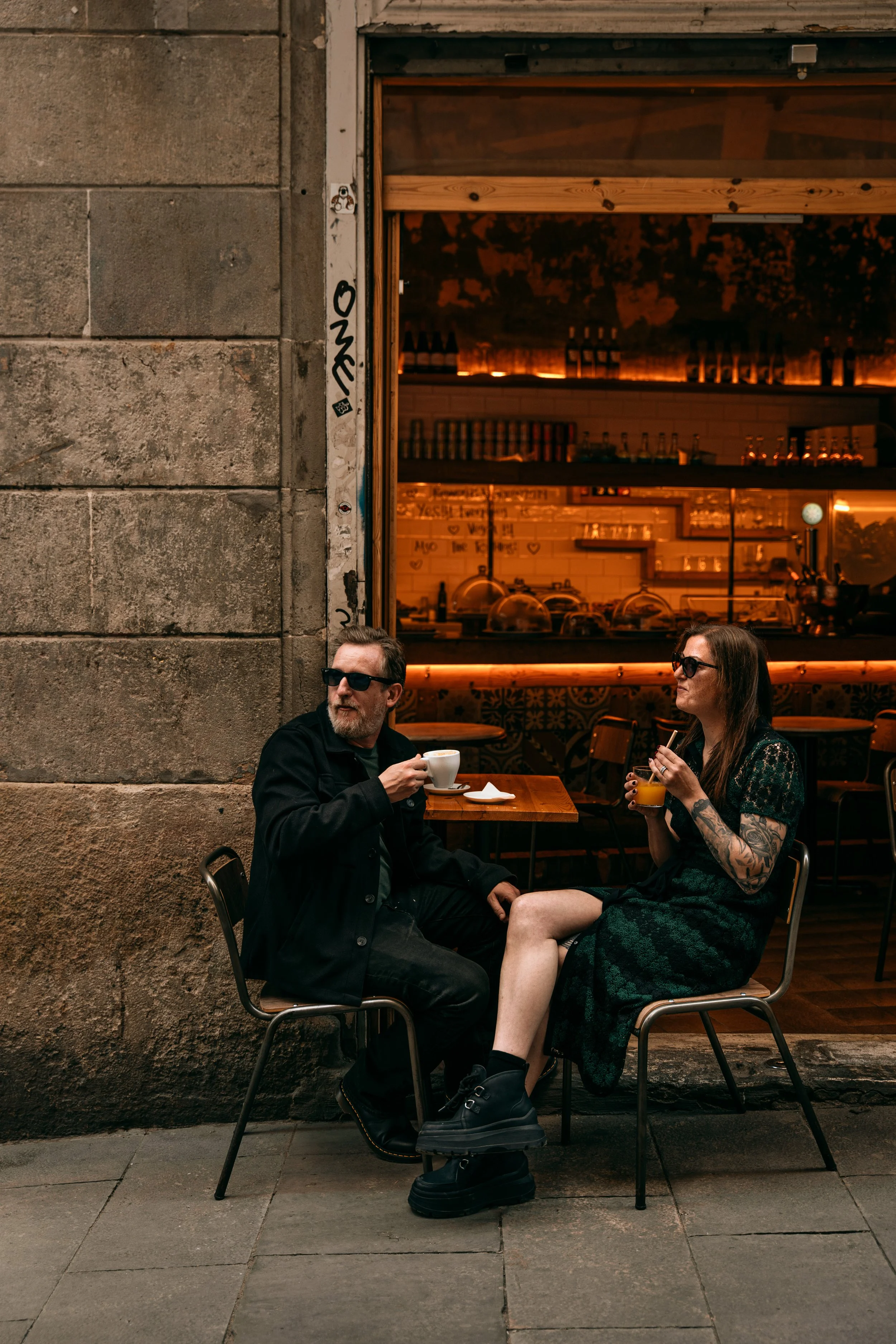 A couple sharing an intimate moment at a Barcelona café. Romantic couples portrait session by Whip and Honey photographer.