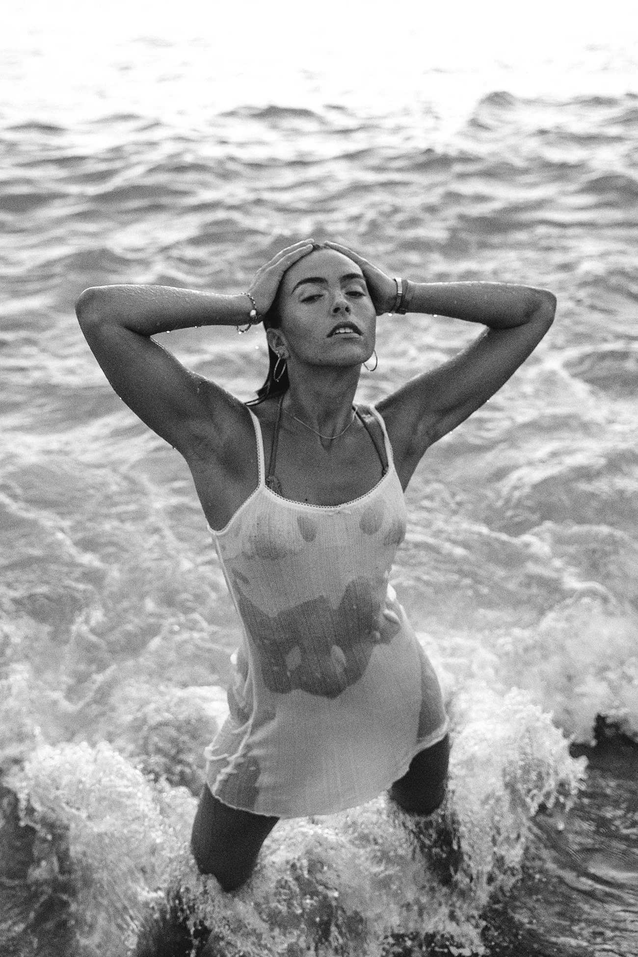 Black and white individual portrait of a woman in the ocean in Barcelona — Whip & Honey photographer
