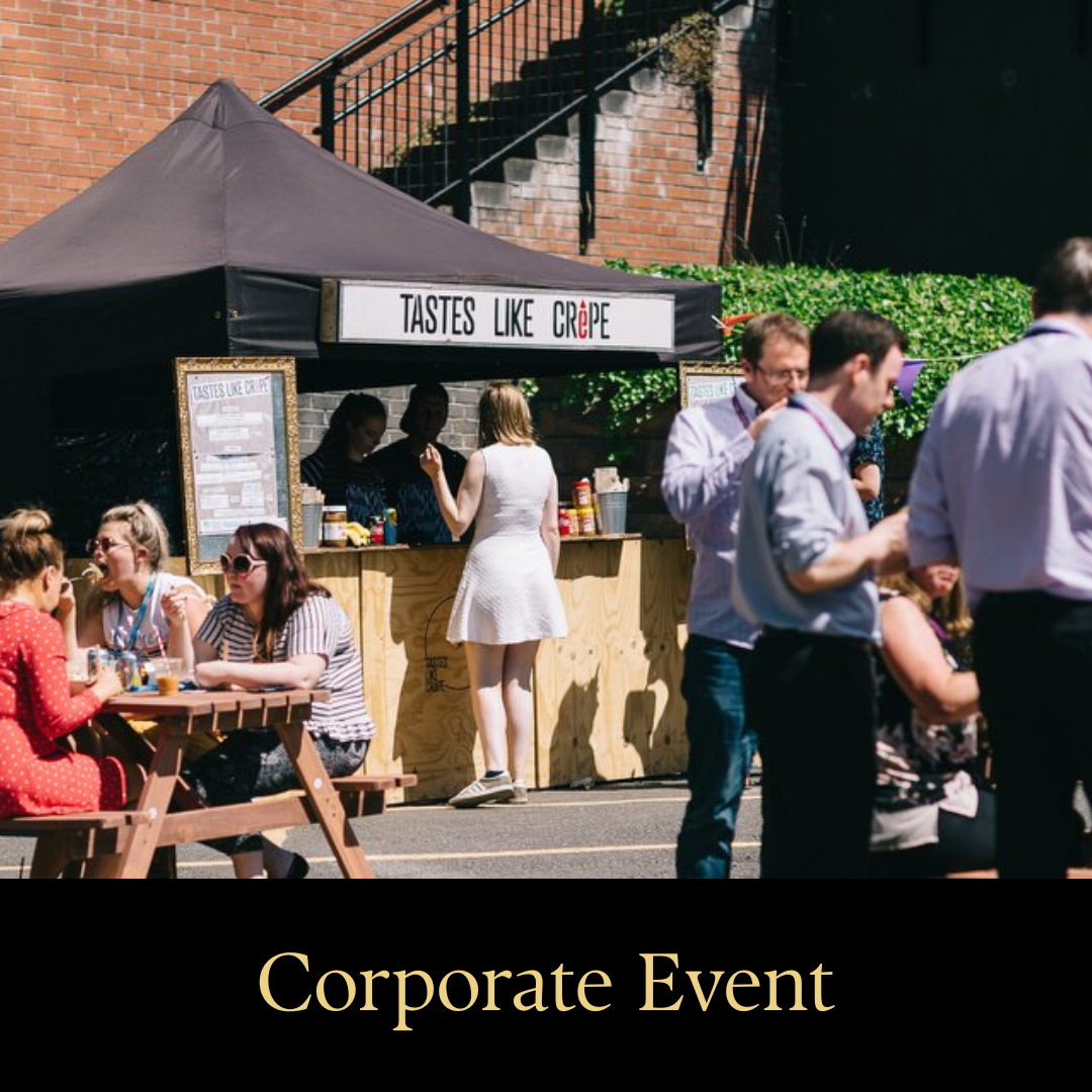 Corporate catering setup for a company event with street food and outdoor dining