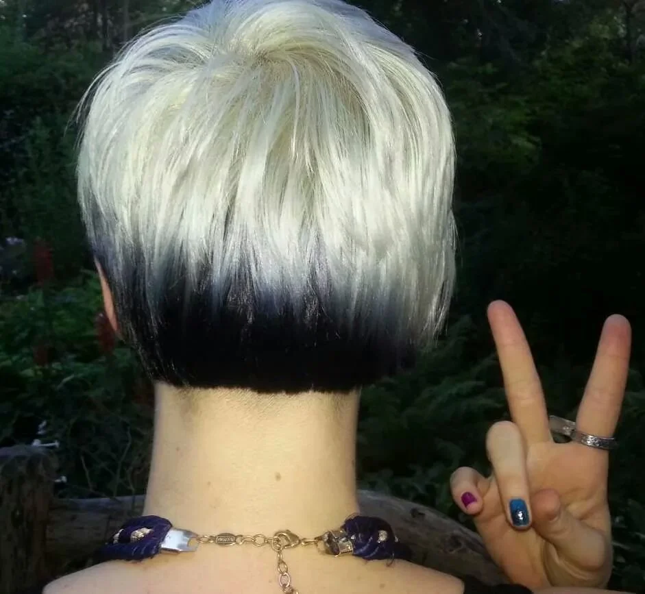 back of cassandra's head as she does peace sign with fingers
