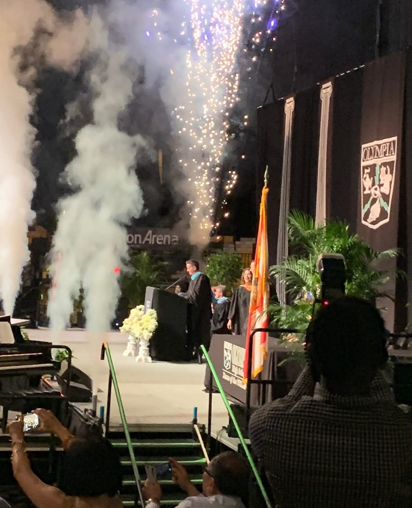 Guy Swenson speaking at an Olympia High School graduation ceremony with fireworks at Amway Arena in Orlando Florida