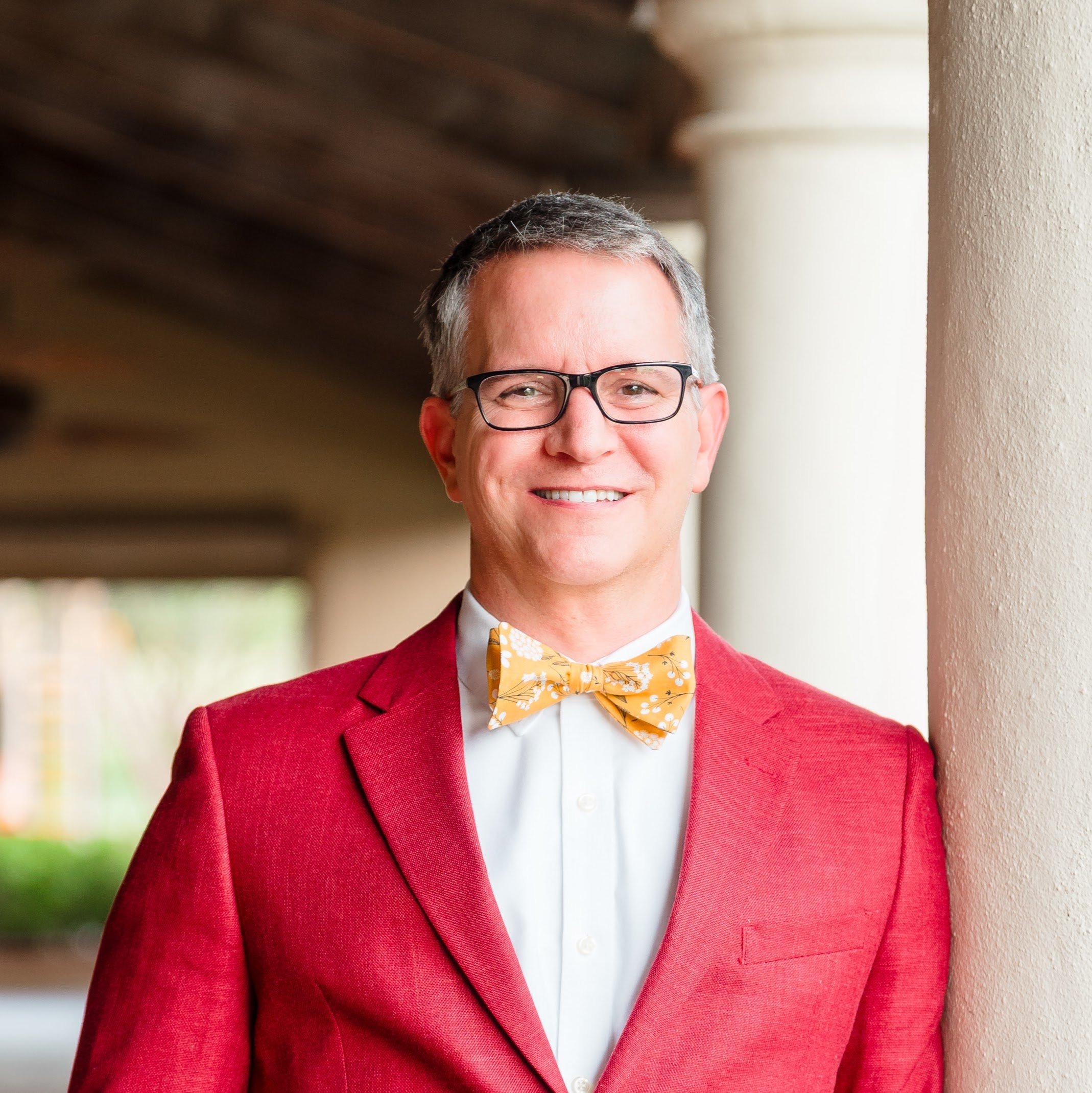 Guy Swenson Ed.D. founder of Index and Atlas K-12 educational leader and digital presence consultant in Orlando Florida wearing a red jacket and gold bow tie