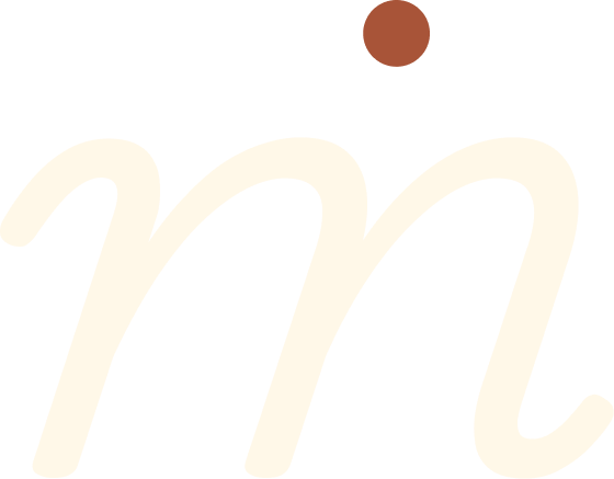 A stylized beige letter m with a brown dot above and to the right of the letter.