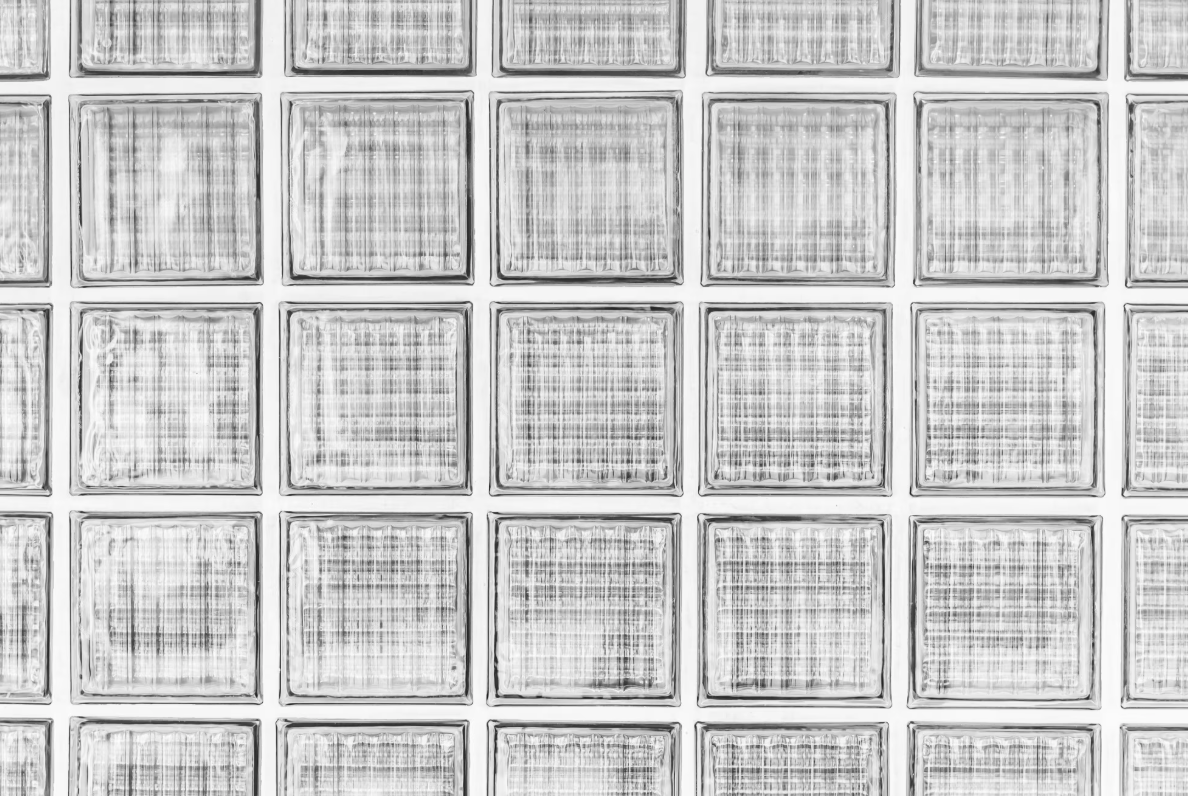 Close-up of a wall made of glass blocks with textured surfaces.