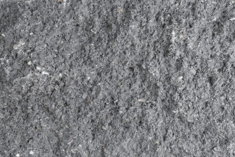 Close-up of gray asphalt or gravel surface.