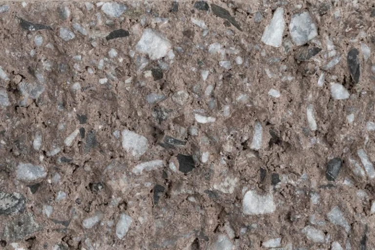 Close-up of a dirt and gravel surface with small stones of various colors